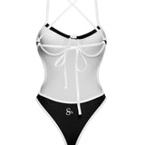Back angle view of black and white one-piece showing sculpted fit and high-cut design
