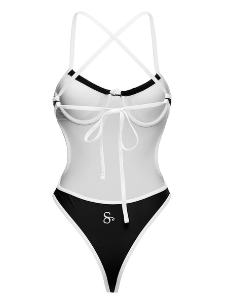 Back angle view of black and white one-piece showing sculpted fit and high-cut design