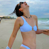 Front studio shot of a model wearing the SBOVIA Oro Puro asymmetrical metallic gold monokini with a single-shoulder strap and custom gold 