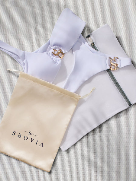SBOVIA Oro Puro metallic gold monokini packed in SBOVIA branded bag with signature luxury packaging