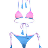 Front angle view of sky blue and pink pastel bikini on model